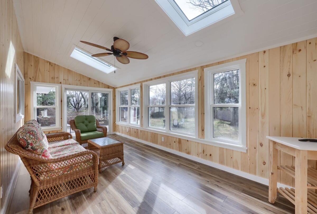 sun room with wood paneling walls and ceiling
