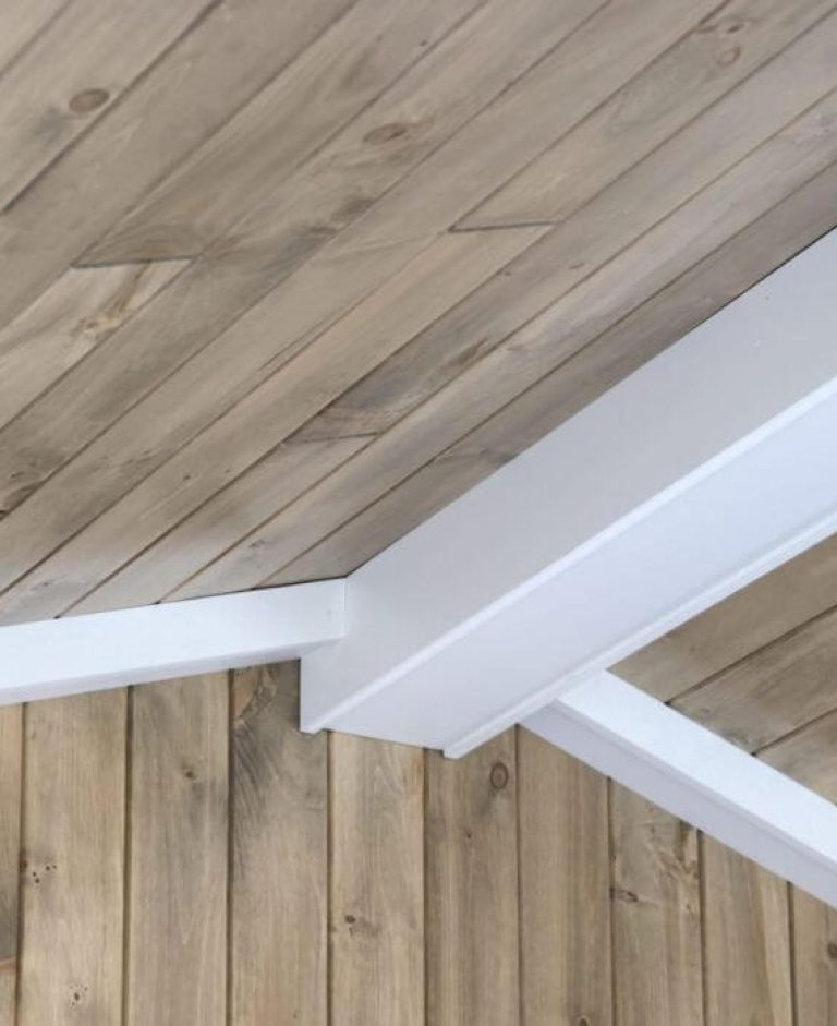 slanted wooden ceiling with white beams