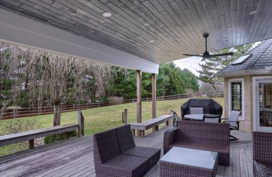 outdoor deck with wooden flooring, wood panel ceiling, and outdoor furniture