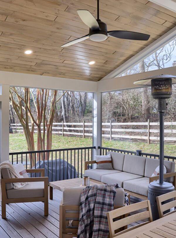 outdoor deck with wooden paneling on floor and ceiling with outdoor furniture