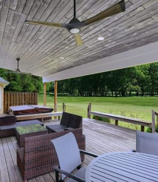 outdoor deck with wood flooring, wood paneling ceiling, and outdoor furniture